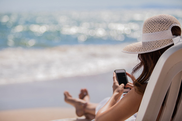 using phone on beach holiday